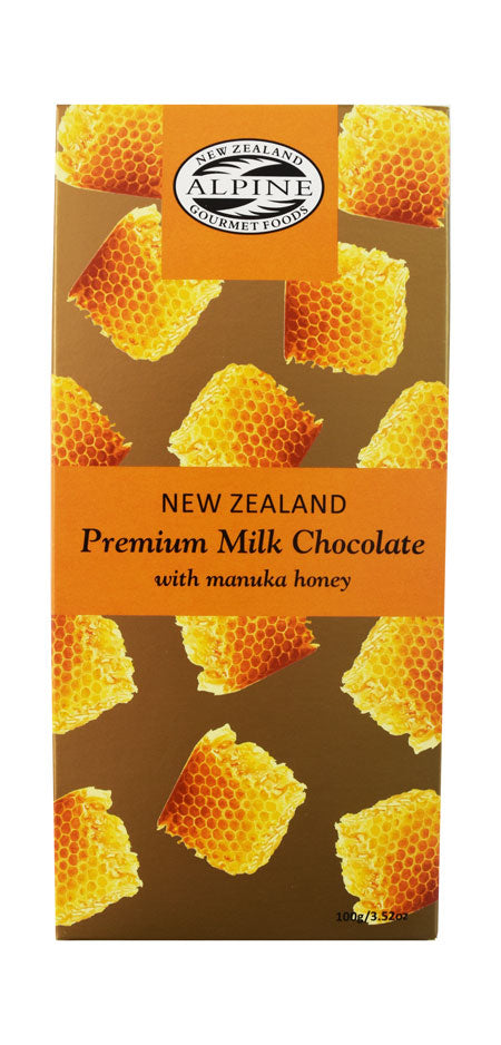 Yellows and orange packaging for a chocolate bar, rectangle shape with honeycomb art scattered over packaging with words over the top 