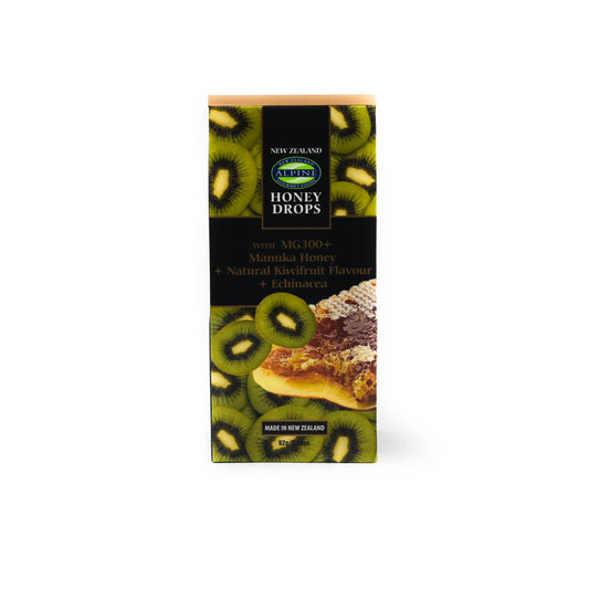 Pouch of Green Kiwifruit Manuka Honey drops on a white background. 
The pouch green with the green kiwifruit slices photos with a honeycomb image middle right. 
Centre is black with some text and top centre is the blue and green oval logo of alpine gourmet. 