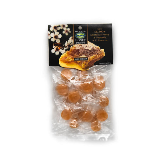Image of a packet of honey drops with clear plastic. cardboard header has image of manuka flowers with bees, honeycomb and some text.