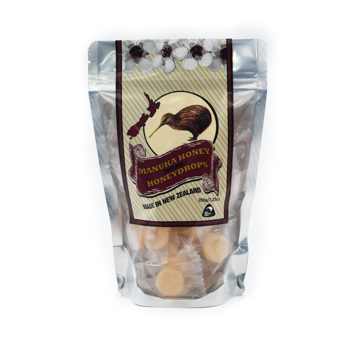Manuka Honey drops in a clear pouch where you can see individually wrapped honey drops. The label has manuka flowers, a map of NZ and a kiwi bird. 