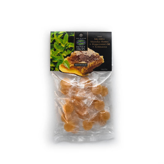A clear bag containing individually wrapped Manuka Honey Drops with Peppermint oil and Echinacea. The label indicates that the product is made in New Zealand and has an image of Peppermint leaves and honeycomb