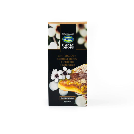 Pouch of Propolis Honey drops on a white backdrop. Pouch is a black colour with manuka flowers, text and Manuka honeycomb on it. The alpine Gourmet logo is top centre and is green and blue.