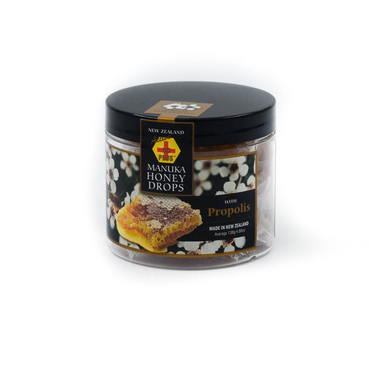 A clear jar with black lid containing individually wrapped Active 10+ Manuka Honey Drops with Propolis and Echinacea. The label indicates that the product is made in New Zealand and has an image of manuka flowers and honeycomb 